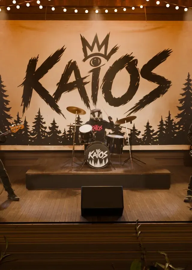 The KAiOS banner with its crown, eye and pine trees, hanging behind the stage